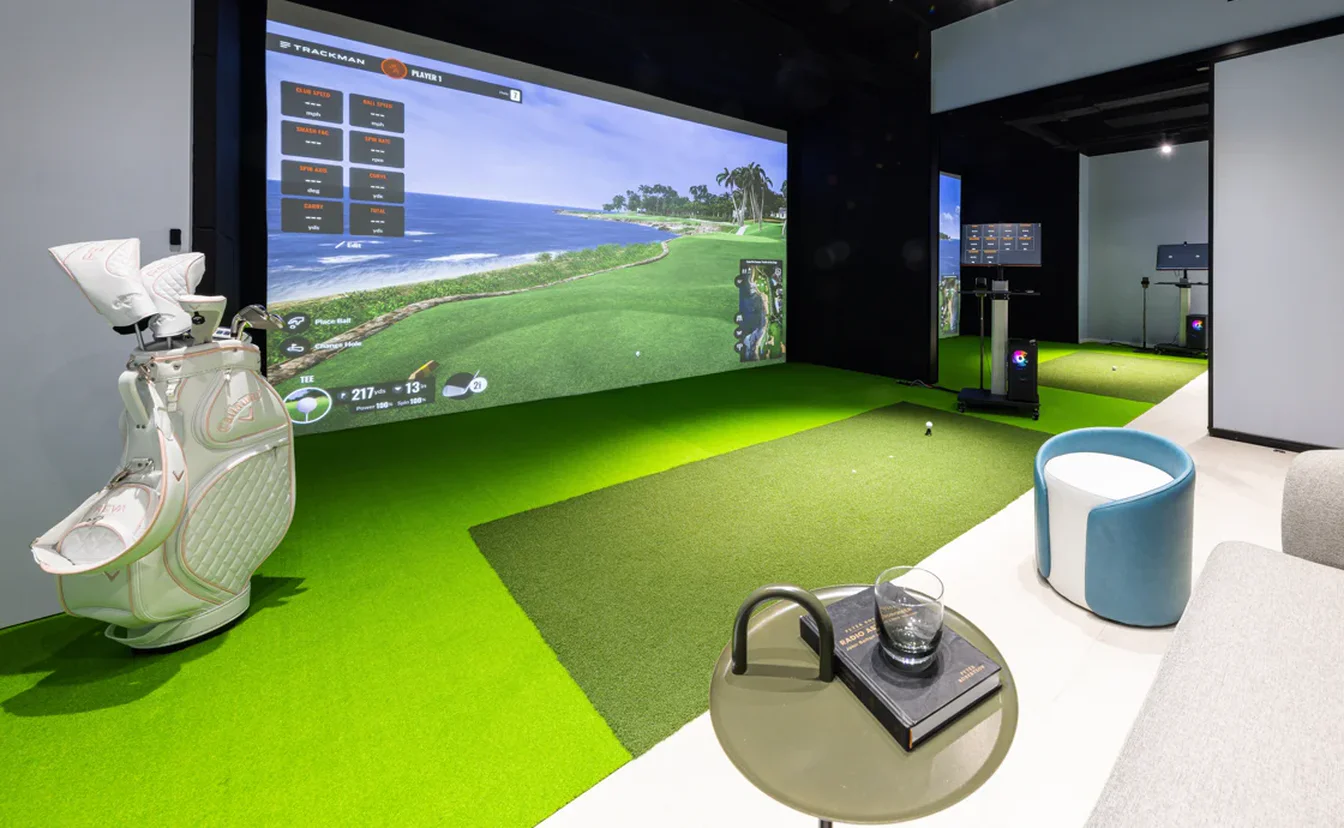 Private Trackman bay with clubs beside the hitting mat